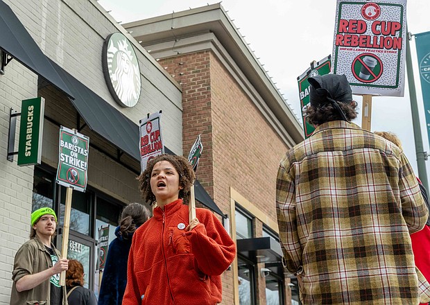 Hope Maddox, a Starbucks barista, joins the Richmond Starbucks Workers United picket line on Wednesday, Nov. 26, outside the West Cary Street location. Baristas from multiple stores across the city participated in the unfair labor practice strike — one of many held at 95 stores in 65 cities nationwide, involving more than 2,000 union Starbucks workers. Julianne Tripp Hillian / Richmond Free Press