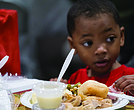 Aiden Sales enjoys a Thanksgiving meal at The Giving Heart’s 20th annual Thanksgiving Day Feast at the Greater Richmond Convention Center.