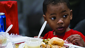 Aiden Sales enjoys a Thanksgiving meal at The Giving Heart’s 20th annual Thanksgiving Day Feast at the Greater Richmond Convention Center.