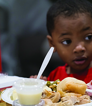 Aiden Sales enjoys a Thanksgiving meal at The Giving Heart’s 20th annual Thanksgiving Day Feast at the Greater Richmond Convention Center.