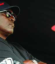 Michael Jordan, co-owner of 23XI Racing, sits in his pit box during a NASCAR Cup Series auto race at Talladega Superspeedway in Talladega, Ala., on Oct. 6, 2024.