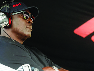 Michael Jordan, co-owner of 23XI Racing, sits in his pit box during a NASCAR Cup Series auto race at Talladega Superspeedway in Talladega, Ala., on Oct. 6, 2024.