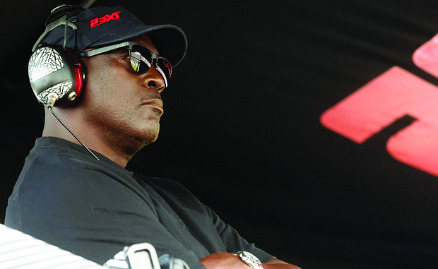 Michael Jordan, co-owner of 23XI Racing, sits in his pit box during a NASCAR Cup Series auto race at Talladega Superspeedway in Talladega, Ala., on Oct. 6, 2024.
