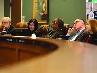 Senators listen to speakers at a Senate Finance and Appropriations subcommittee meeting on higher education on Monday.