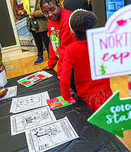 Soul of Christmas-Children and families visited the Black History Museum &
Cultural Center of Virginia on Nov. 29 for the annual Soul Santa Experience. The museum will host two more Saturdays, Dec. 6 and Dec. 13, from 11 a.m. to 3 p.m. as part of Community Access Days with free admission and optional donations. Attendees can hear holiday stories, join arts and crafts activities and browse the museum gift shop for items such as the Ebonyopoly board game. Kyndal Davis, 4, colors a holiday picture in the arts and crafts section of the Black History Museum’s annual Soul Santa Experience. (photo by Julianne Tripp Hillian/Richmond Free Press)