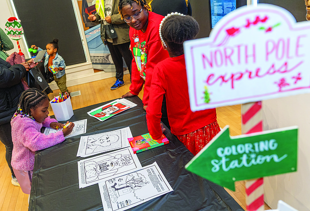 Soul of Christmas-Children and families visited the Black History Museum &
Cultural Center of Virginia on Nov. 29 for the annual Soul Santa Experience. The museum will host two more Saturdays, Dec. 6 and Dec. 13, from 11 a.m. to 3 p.m. as part of Community Access Days with free admission and optional donations. Attendees can hear holiday stories, join arts and crafts activities and browse the museum gift shop for items such as the Ebonyopoly board game. Kyndal Davis, 4, colors a holiday picture in the arts and crafts section of the Black History Museum’s annual Soul Santa Experience. (photo by Julianne Tripp Hillian/Richmond Free Press)