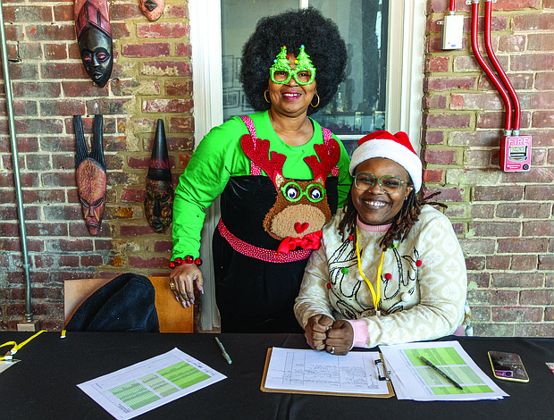 Soul of Christmas-Children and families visited the Black History Museum &
Cultural Center of Virginia on Nov. 29 for the annual Soul Santa Experience. The museum will host two more Saturdays, Dec. 6 and Dec. 13, from 11 a.m. to 3 p.m. as part of Community Access Days with free admission and optional donations. Attendees can hear holiday stories, join arts and crafts activities and browse the museum gift shop for items such as the Ebonyopoly board game. Volunteers Michaele’ McKeever-Davis and
Trayc Freeman welcome guests to the museum. (photo by Julianne Tripp Hillian/Richmond Free Press)
