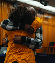 Alumni from John F. Kennedy High School celebrate after the School Board voted to rename Armstrong High School to Armstrong-Kennedy High School.