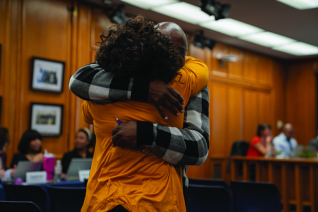 Alumni from John F. Kennedy High School celebrate after the School Board voted to rename Armstrong High School to Armstrong-Kennedy High School.