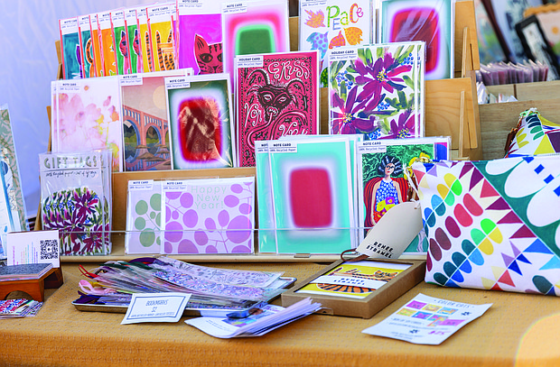 Small Business Saturday brings community, commerce together-Shoppers filled Sheppard Street on Nov. 29 for the Small Business Saturday Market hosted by RVA Galleries between Floyd and Ellwood avenues. The market featured 75 vendors offering everything from ceramics and fine art to spirits and locally made food. Cards and goods made by Renee Stramel are displayed at the market. ((photo by Julianne Tripp Hillian/Richmond Free Press)