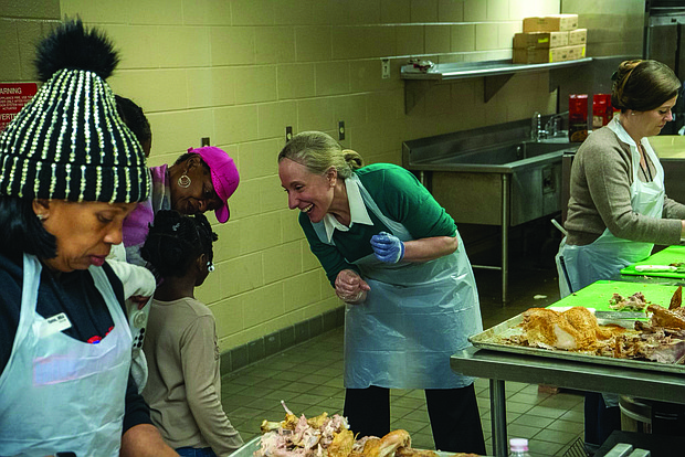 A Thanksgiving of service-The Giving Heart marked its 20th annual Thanksgiving Day Feast last Thursday at the Greater Richmond Convention Center, drawing more than 1,000 people to the exhibit hall for a day centered on meals and community connection. Gov-elect Abigail Spanberger and her family help prepare meals. (Photo courtesy of Abigail Spanberger)