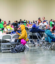 A Thanksgiving of service-The Giving Heart marked its 20th annual Thanksgiving Day Feast last Thursday at the Greater Richmond Convention Center, drawing more than 1,000 people to the exhibit hall for a day centered on meals and community connection. Guests receive free meals, flu shots, clothing and other items at the convention center. (photo by Sandra Sellars/Richmond Free Press)