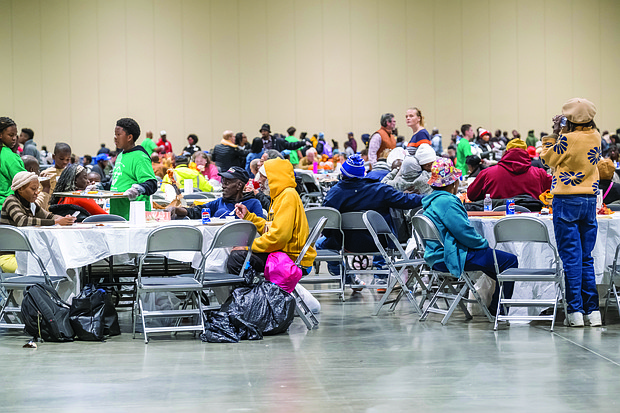 A Thanksgiving of service-The Giving Heart marked its 20th annual Thanksgiving Day Feast last Thursday at the Greater Richmond Convention Center, drawing more than 1,000 people to the exhibit hall for a day centered on meals and community connection. Guests receive free meals, flu shots, clothing and other items at the convention center. (photo by Sandra Sellars/Richmond Free Press)