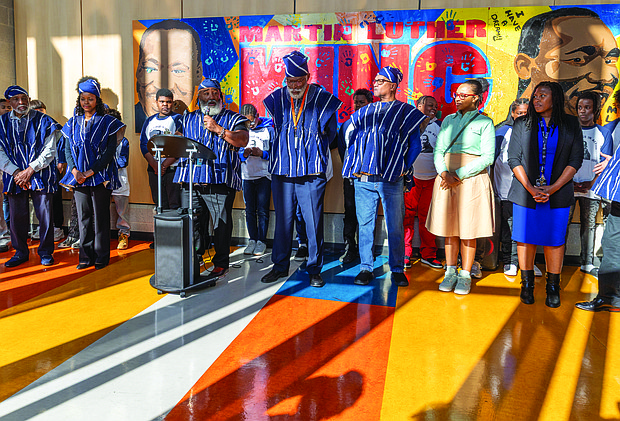 Lighting the way for healing and change-In Richmond, the Drums No Guns Foundation recently celebrated a $96,638 Health Equity Fund grant from the Richmond and Henrico Public Health Foundation to support youth mental and behavioral health in schools affected by community violence. The year-long project, led by Ram Bhagat and coordinated by Kiran Bhagat, brings restorative justice practices to Martin Luther King Jr. Middle School, in collaboration with community-based educators, artists and public health partners. Olufemi Shepsu, a school social worker, speaks at a news conference, joined by social workers, teachers, counselors, and student support specialists involved in implementing the Drums No Guns program. (Photo by Julianne Tripp Hillian/Richmond Free Press)