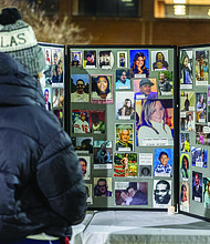 Lighting the way for healing and change-Henrico County’s held its annual Candlelight & Ribbon Tying Ceremony on Tuesday to honor homicide victims. Sponsored by the Henrico County Commonwealth’s Attorney’s Victim/Witness Program, the event featured prayer, remarks from friends and family of the deceased, a memorial board of photographs and a memorial tree where participants placed the names of those they have lost. Early reports show the county has recorded just two homicides through December 2025, down from 22 during the same period last year — a potential 91% decrease if the trend holds through year’s end. Attendees pause at the memorial board displaying photos of loved ones. (Photo by Julianne Tripp Hillian/Richmond Free Press)