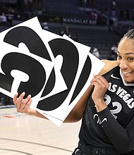 Las Vegas Aces center A’ja Wilson (22) holds up numbers to commemorate her WNBA career 5,000 points after the Aces defeated the Connecticut Sun in a WNBA basketball game on June 25 in Las Vegas.