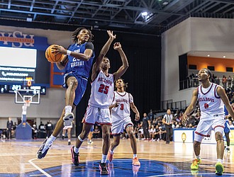 Ahmad Britt #23 of John Marshall High School drives to the basket during the “Battle of Richmond” at the VSU Multipurpose Center on Saturday, Dec. 6. John Marshall defeated Richmond School for the Arts 78-51.