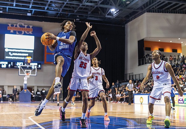 Ahmad Britt #23 of John Marshall High School drives to the basket during the “Battle of Richmond” at the VSU Multipurpose Center on Saturday, Dec. 6. John Marshall defeated Richmond School for the Arts 78-51.