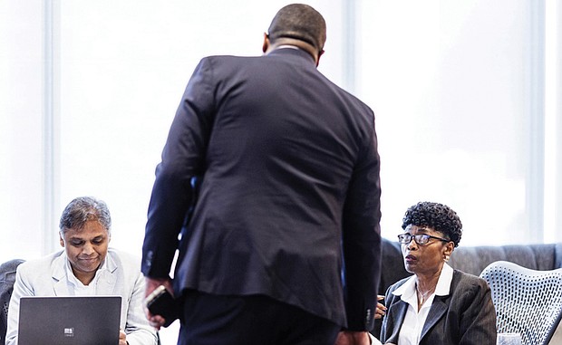 Richmond Chief Administrative Officer Odie Donald chats with Mayor Danny Avula and Council President Cynthia Newbille before their joint session on the budget on Dec. 4.