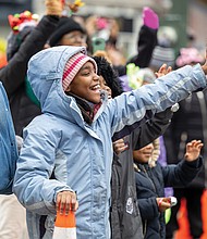 Christmas on Broad Street-The 42nd annual Dominion Energy Christmas Parade returned to Broad Street in Richmond on Saturday, Dec. 6. The parade began at 10 a.m. at the Science Museum of Virginia and continued east to Seventh Street. Madison Reed waves to Santa as he passes. (photo by Julianne Tripp Hillian/Richmond Free Press)