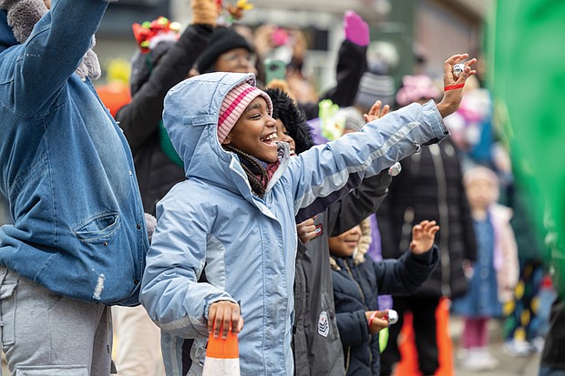 Christmas on Broad Street-The 42nd annual Dominion Energy Christmas Parade returned to Broad Street in Richmond on Saturday, Dec. 6. The parade began at 10 a.m. at the Science Museum of Virginia and continued east to Seventh Street. Madison Reed waves to Santa as he passes. (photo by Julianne Tripp Hillian/Richmond Free Press)