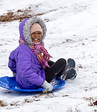 A snow day-Richmond’s first snow day of the season arrived Friday,
Dec. 5, sending some commuters into the city slower than usual, while school closures gave children a chance to trade backpacks for sleds. Noelle Ketter, 9, of Evergreen Elementary School, spent her day racing down the hills at Forest Hill Park. (photo by Julianne Tripp Hillian/Richmond Free Press)