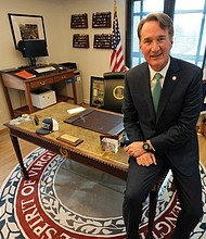 Gov. Glenn Youngkin gestures during an interview in his office at the Capitol in Richmond on Dec. 10.