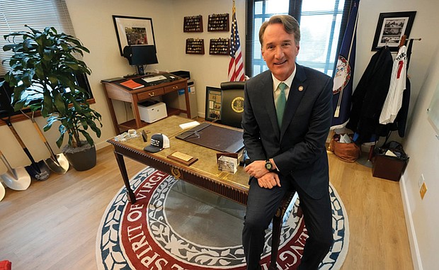 Gov. Glenn Youngkin gestures during an interview in his office at the Capitol in Richmond on Dec. 10.
