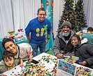 Jesus Ibanez, general manager for Lego Manufacturing Virginia, poses with attendees at a Build to Give event at the Children’s Museum of Richmond in Chesterfield County on Friday.