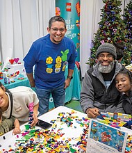 Jesus Ibanez, general manager for Lego Manufacturing Virginia, poses with attendees at a Build to Give event at the Children’s Museum of Richmond in Chesterfield County on Friday.