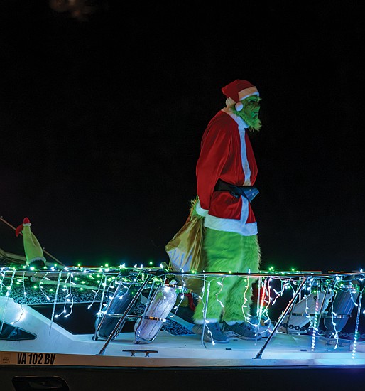 Holiday magic lights up the James River-
The Richmond Boat Parade of Lights returned Saturday, Dec. 13 starting at 5 p.m. from Rocketts Landing and cruising downriver to Osborne
Park & Boat Landing near The Lilly Pad restaurant around 7 p.m. Hundreds watched along the river and at popular viewing spots like Libby Hill
and Osborne Park. Several brightly lit boats make their way down the James River, their colorful lights reflecting in the water. Boats decorated
with holiday lights cruise down the James River, including one carrying a surfing Santa Claus. (photo by Sandra Sellars/Richmond Free Press)