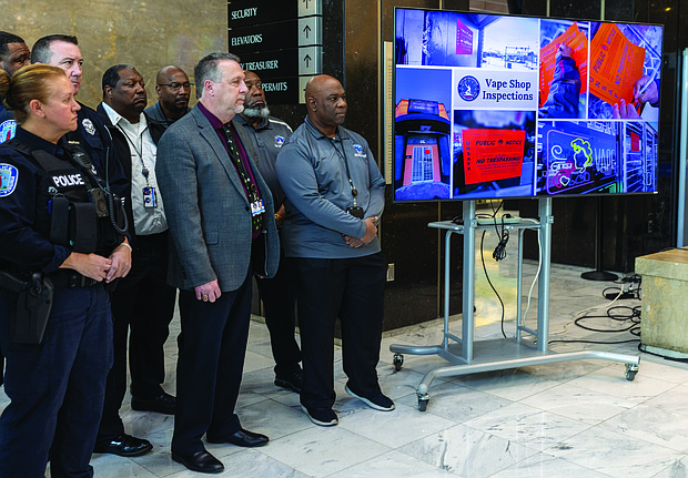 City officials gather at a news conference on Operation Vaporize at City Hall on Friday.