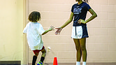 Timani Harris greets a young participant during her basketball clinic at Trinity Family Life Center in Richmond on Saturday.