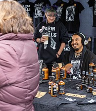Carytown market blends local shopping with community support-Shoppers explored the Carytown Queer Cheer Holiday Market organized by TransJam on Sunday, Dec. 21. The event offered local gifts while supporting queer and trans community members in need. Attendees also contributed to the Big GAY Give, which funds microgrants for queer and trans individuals. TransJam hosts similar markets year-round, including its monthly Big Gay Market RVA, with the next flea market–style event scheduled for Jan. 11. Jason Jase Dowdy and partner Ptero Berns greet shoppers and share holiday cheer. (photo by Julianne Tripp Hillian/Richmond Free Press)