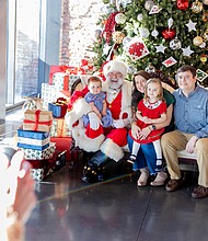 Families meet Santa at American Civil War Museum-Families gathered at the American Civil War Museum on Saturday, Dec. 20, for a holiday celebration featuring a visit from Santa, arts and crafts for children, and a chance to take care of last-minute holiday requests. The Klein family—Kristen and Nick, with Sally, 10 months, and Parker, 3—meets Santa at the American Civil War Museum on Saturday, Dec. 20. (photo by Julianne Tripp Hillian/Richmond Free Press)