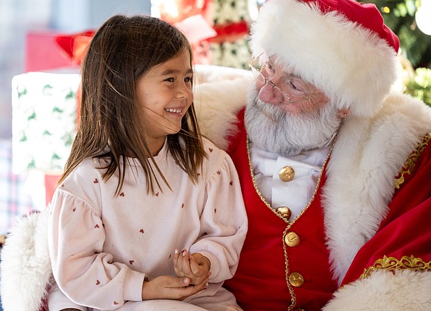 Families meet Santa at American Civil War Museum-Families gathered at the American Civil War Museum on Saturday, Dec. 20, for a holiday celebration featuring a visit from Santa, arts and crafts for children, and a chance to take care of last-minute holiday requests. Ana Gomez, 5, asks Santa for a stuffed animal during his visit. (photo by Julianne Tripp Hillian/Richmond Free Press)