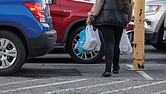 A shopper exits a grocery store with plastic bags, which will be subject to a new tax taking effect statewide Jan. 1. Retailers will be required to collect a 5-cent fee for each disposable plastic bag they provide customers.