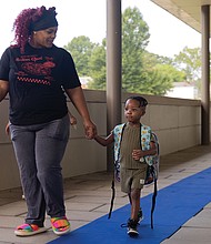 A Year in Focus-From marches to milestones, Richmond’s people and events shaped the year. Demonstrations, school celebrations, cultural festivals and sports brought the community together across the city. These images capture the moments that marked 2025 in Richmond. Legend Agamah and his mother head into his first day of pre-K at Oak Grove-Bellemeade Elementary
School on July 21. Oak Grove-Bellemeade is one of four Richmond Public Schools operating on a 200-day calendar.(photo by Julianne Tripp Hillian/Richmond Free Press)