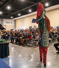 Kwanzaa festival elevates African heritage-Stilt walkers pay tribute to ancestors during the annual Capital City Kwanzaa Festival at the Richmond
Convention Center on Saturday, Dec. 27. Virginia’s largest Kwanzaa celebration brings together vibrant performances, hands-on workshops, children’s activities. The African Market and authentic cuisine—all honoring the holiday’s seven principles of unity, self-determination,
collective work, cooperative economics, purpose, creativity and faith. (photo by Sandra Sellars/Richmond Free Press)