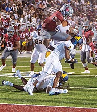A Year in Focus-From marches to milestones, Richmond’s people and events shaped the year. Demonstrations, school celebrations, cultural festivals and sports brought the community together across the city. These images capture the moments that marked 2025 in Richmond. Virginia Union running back Curtis Allen leaps over a defender to score a touchdown on Sept. 20 as the Panthers defeated Johnson C. Smith 28-10 in the Willard
Bailey Classic at Hovey Field.  (photo by James Haskins/Richmond Free Press)