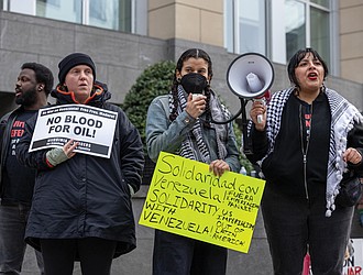 LJ Delao, center, speaks during a protest outside the federal courthouse in Downtown Richmond on Jan. 3. Demonstrators opposed the U.S. military action in Venezuela and called for the release of Venezuelan President
Nicolás Maduro and his wife, Cilia Flores.