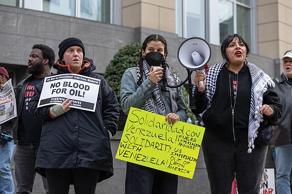 About 100 residents and organizers rallied Saturday to condemn a controversial U.S. military operation in Venezuela that included strikes on …