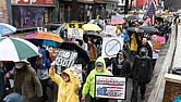 A sea of umbrellas and protest signs filled streets in Downtown Richmond on Saturday as demonstrators rallied and marched from Maggie Walker Memorial Plaza to Abner Clay Park.