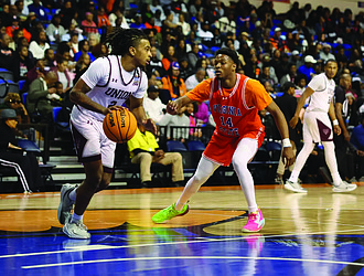 Virginia Union’s Travis Vaughn drives against Virginia State’s William Hopkins during the Panthers’ 65-37 victory in the Freedom Classic at the VSU Multi-Purpose Center on Saturday. Hopkins led the Trojans with 12 points