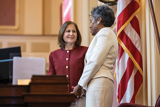Ladies and gentlemen … start your terms- Virginia turns a page as lawmakers take their oaths and Gov. Abigail Spanberger was inaugurated last week. The first day of the 2026 General Assembly session on Jan. 14 saw delegates and state leaders assume their roles. Former Lt. Gov. Winsome Earle‑Sears speaks with Ghazala Hashmi, now lieutenant governor, at the center desk of the Senate chamber on the first day of the General Assembly session at the Capitol. (photo by Julianne Tripp Hillian/Richmond Free Press)
