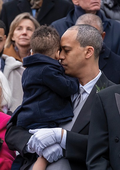Attorney General Jay Jones comforts his son, Zachary, as Abigail Spanberger is sworn in as Virginia’s 75th governor and first woman to hold the office. (photo by Sandra Sellars/Richmond Free Press)
