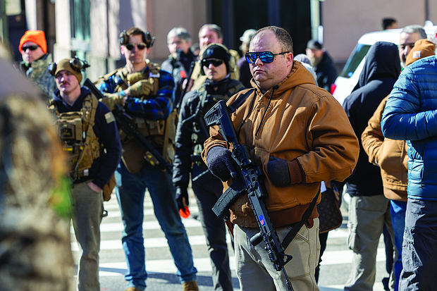 Voices raised for peace and change on MLK Day-Richmonders marked Martin Luther King Jr. Day with a series of events, including Virginia Union University’s 47th annual community leaders breakfast, a candlelight vigil for peace outside the Virginia War Memorial, and Lobby Day rallies for gun violence prevention and gun rights at Capitol Square. Gun rights advocates rally-Hundreds gathered at the Bell Tower in Capitol Square on Lobby Day, Jan. 19, for a gun rights rally organized by the Virginia Citizens Defense League. Many attendees carried firearms but were not allowed on Capitol premises and instead formed a group on a blocked-off section of 9th Street. (photo by Julianne Tripp Hillian/Richmond Free Press)