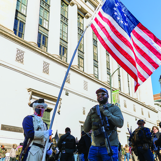 Voices raised for peace and change on MLK Day-Richmonders marked Martin Luther King Jr. Day with a series of events, including Virginia Union University’s 47th annual community leaders breakfast, a candlelight vigil for peace outside the Virginia War Memorial, and Lobby Day rallies for gun violence prevention and gun rights at Capitol Square. Gun rights advocates rally-DJ Hawkins, right, with another attendee, stand outside Capitol Square.(photo by Julianne Tripp Hillian/Richmond Free Press)
