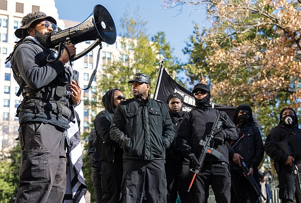 Voices raised for peace and change on MLK Day-Richmonders marked Martin Luther King Jr. Day with a series of events, including Virginia Union University’s 47th annual community leaders breakfast, a candlelight vigil for peace outside the Virginia War Memorial, and Lobby Day rallies for gun violence prevention and gun rights at Capitol Square. Gun rights advocates rally-JaPharii Jones, president of BLM757, speaks to a crowd
on 9th Street outside the Bell Tower. Behind him are other
members of BLM757 and the Original Black Panther Party
of Virginia. (photo by Julianne Tripp Hillian/Richmond Free Press)