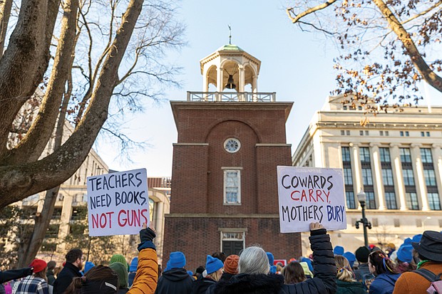 Voices raised for peace and change on MLK Day-Richmonders marked Martin Luther King Jr. Day with a series of events, including Virginia Union University’s 47th annual community leaders breakfast, a candlelight vigil for peace outside the Virginia War Memorial, and Lobby Day rallies for gun violence prevention and gun rights at Capitol Square. Vigil and Advocacy Day for gun violence prevention-Advocates for gun violence prevention gathered at the Bell Tower in Capitol Square on Lobby Day, Jan. 19 for the 34th annual Virginia Vigil and Advocacy Day to Prevent Gun Violence, honoring Dr. Martin Luther King Jr. through advocacy. This event came hours after gun rights lobbyists filled the same space arguing for fewer
gun protections and more gun rights. Protesters hold signs with messages about the impact of gun violence. (photo by Julianne Tripp Hillian/Richmond Free Press)